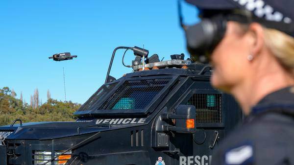 Drone flying next to police