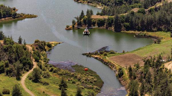 Helicopter flying above lakes
