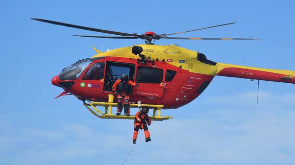 Recue workers hoisting out of helicopter
