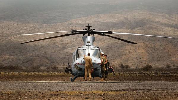 Helicopter parked at bottom of mountain