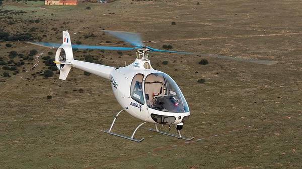 Helicopter flying over field