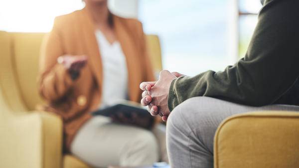 Therapist talking to patient