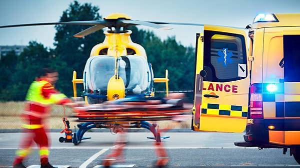 Paramedics loading patient into ambulance