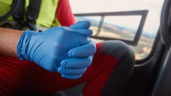 Paramedic in the zone, in helicopter with hands together