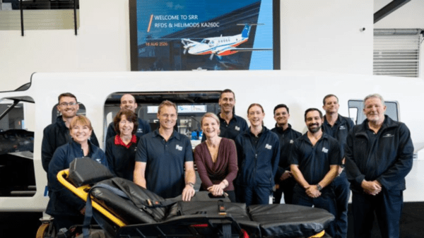 Staff from the Royal Flying Doctor Service stand in front of a stretcher