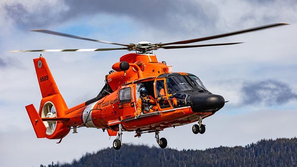 Orange coast guard helicopter in the air
