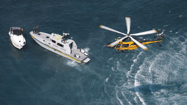Helicopter and boats in the sea