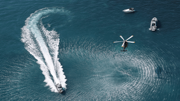 Helicopter and boats in the sea