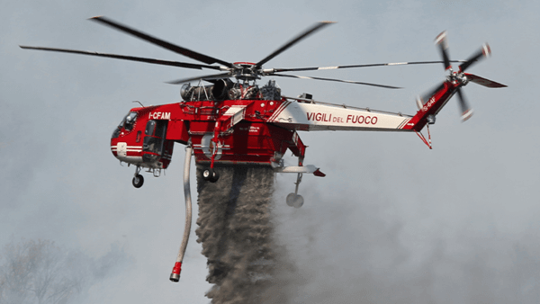 Helicopter releasing fire retardant