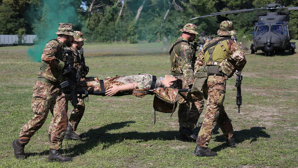 Military medics carrying dummy body