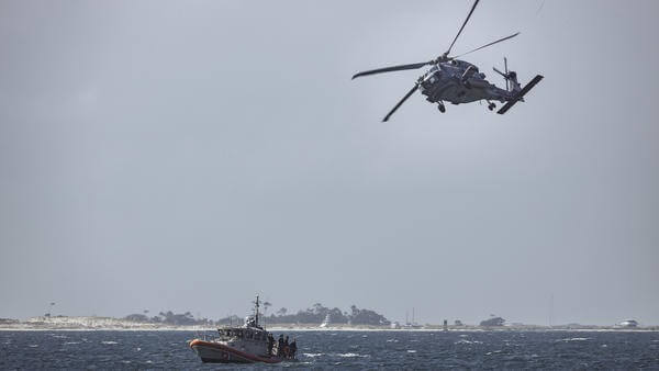 Florida swap navy helicopter flying next to boat