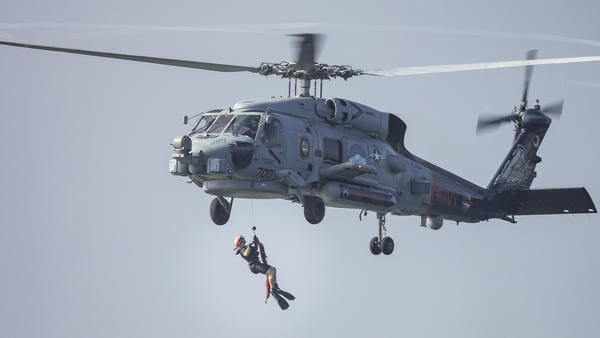 Man hoisting out of Florida swap navy helicopter