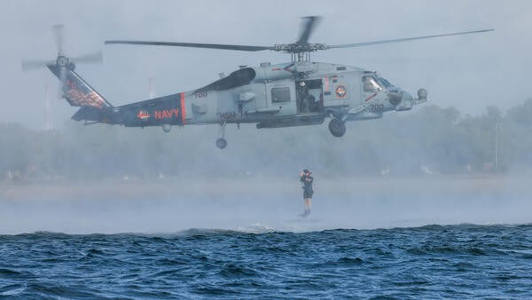 Rescue diver diving into sea