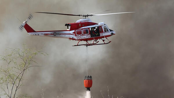 helicopter dropping fire retardant