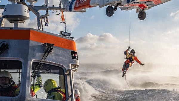Coast guard hoisted out of helicopter above water