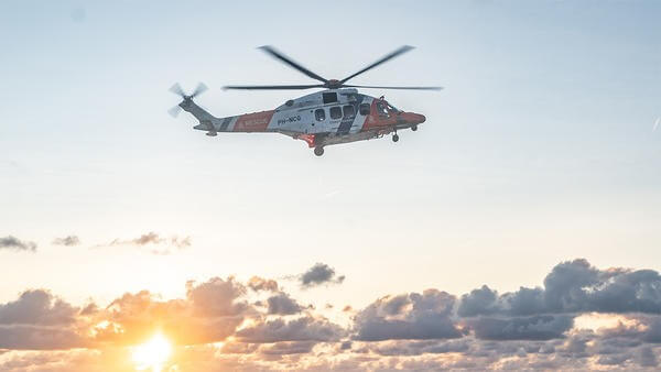 Helicopter flying above sea