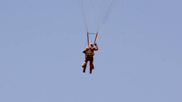 Parachuter in sky