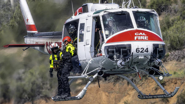 Firefighter about to jump from Cal Fire helicopter