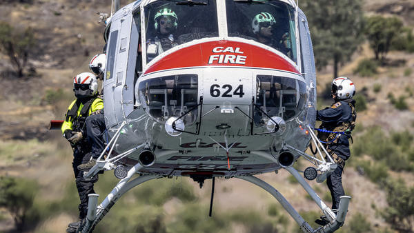 Cal fire firefighters about to hoist out of either side of helicopter