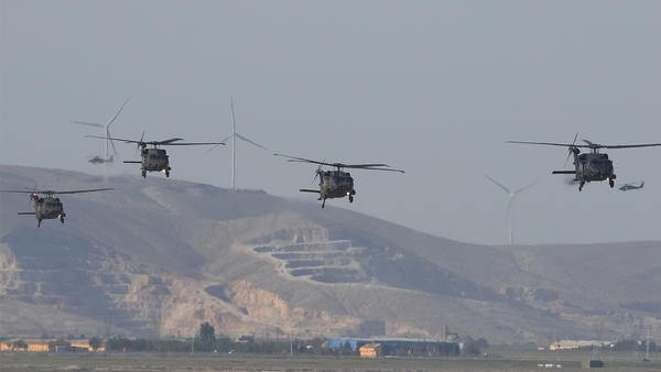 4 helicopters mid-flight