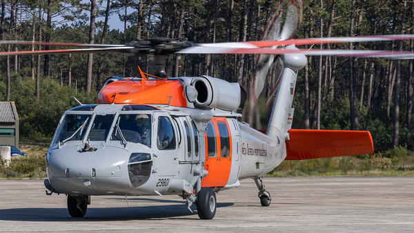 Orange and grey helicopter parked