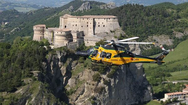 Yellow helicopter flying with castle underneath