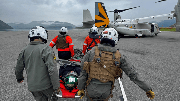 SAR workers bringing patient to helicopter