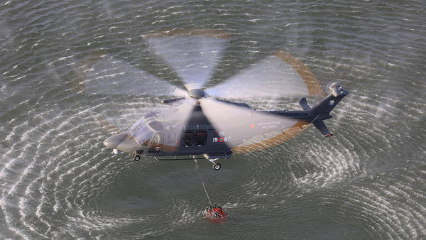 Military helicopter flying above water