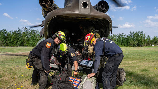 SAR workers getting prepared next to helicopter