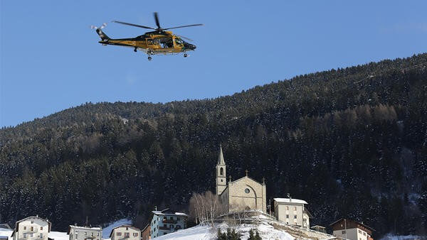 Helicopter flying over Italian snowy town