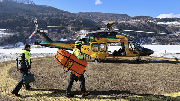 Paramedics walking to parked helicopter