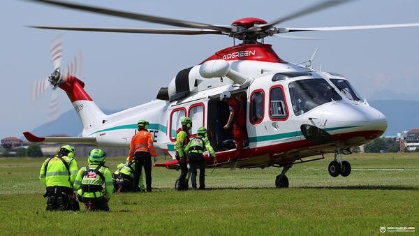 Helicopter about to take off with rescue personnel getting onboard